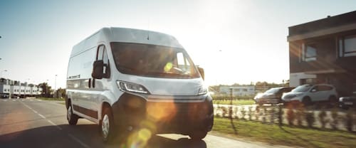 New,Delivery,Van,/,Truck,Driving,Through,The,Beautiful,Suburban