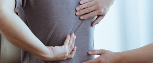 Doctor,Or,Physical,Therapist,Examines,Back,Pain,And,Spinal,Area