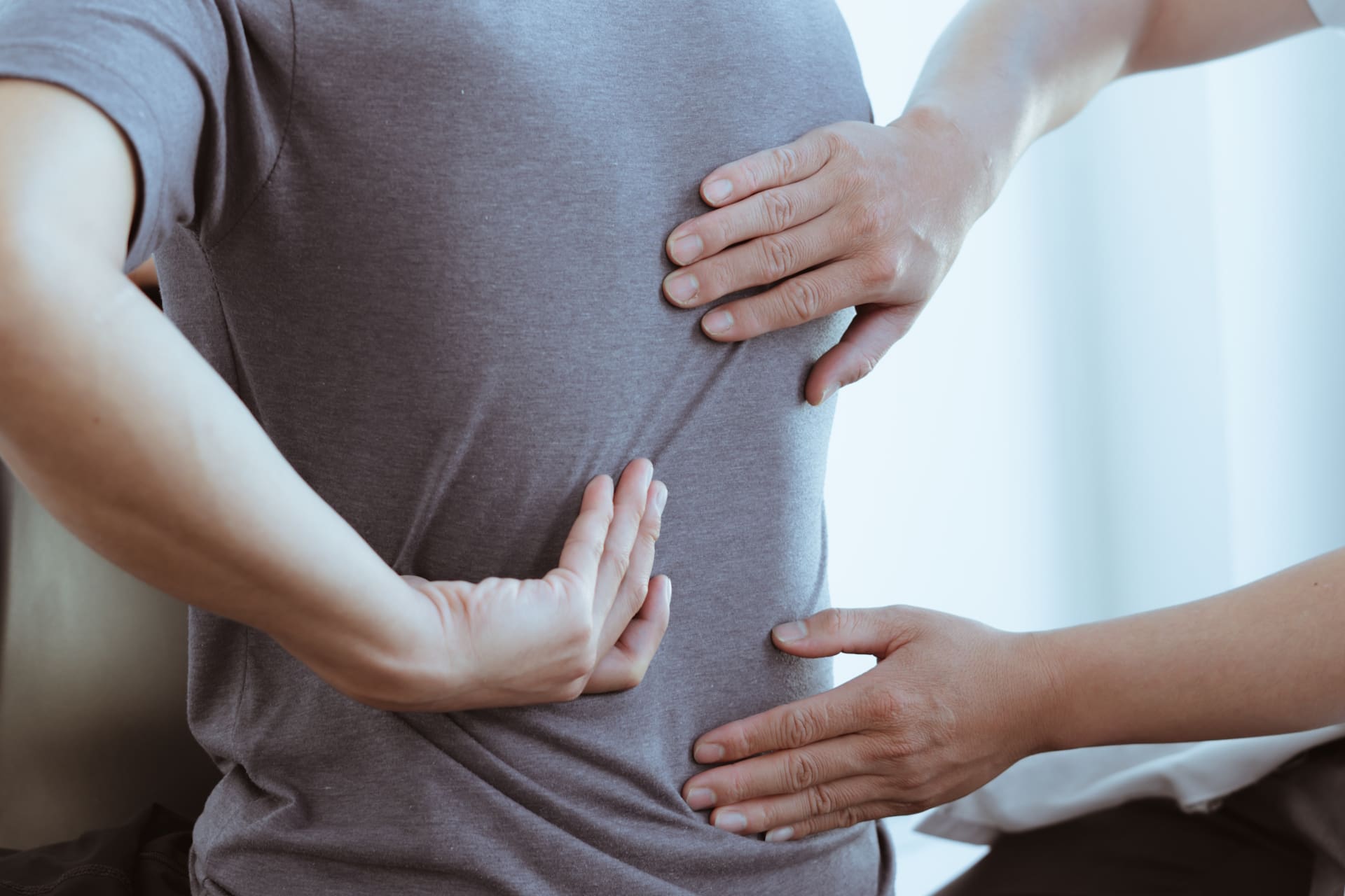Doctor,Or,Physical,Therapist,Examines,Back,Pain,And,Spinal,Area